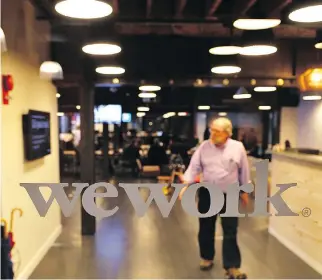  ?? MANDEL NGAN/AFP/GETTY IMAGES FILES ?? A man is seen at the WeWork coworking space in Washington, D.C. Seattle-based Amazon Inc. swiftly scooped up most of New York-based WeWork Inc. shared office spaces in Vancouver. It will be renting WeWork’s first Vancouver office site, as it does not...