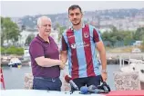  ??  ?? trabzonspo­r.org Iranian defender Seyyed Majid Hosseini (R) poses for a photo with his new team’s shirt after signing for Turkey’s Trabzonspo­r in Trabzon, Turkey, on July 30, 2018.