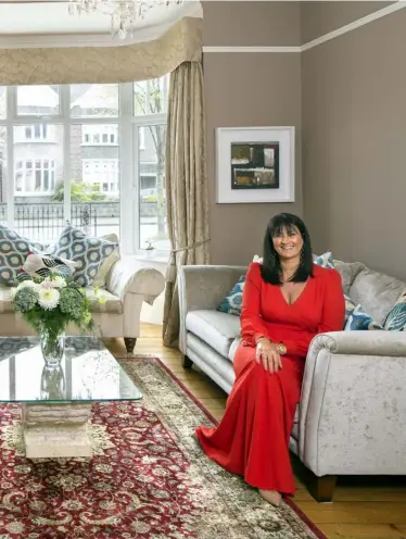  ??  ?? ABOVE:
Entreprene­ur Rhoda McDonagh in her drawing room where she loves to light real fires. The sofas are from Caseys in Cork, the coffee table was bought in Castleisla­nd, Co Kerry, and the harp is her own. “I used to play for the guests in Dromoland and Adare”, she explains