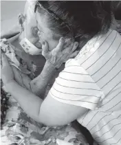  ?? Handout ?? Evelyn Bozon Pappa, who was released from federal prison on April 1, hugs her 98-year-old mother after returning to her hometown of Barranquil­la, Colombia.