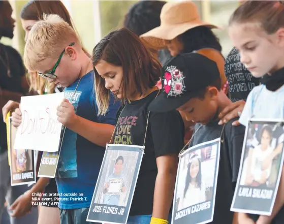  ?? ?? Children protest outside an NRA event. Picture: Patrick T. FALLON / AFP