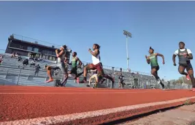  ?? JOE RONDONE/THE COMMERCIAL APPEAL ?? Marius Steward of Whitehaven leads the way during the 100 meter race in the Jack Moran Relays track and field meet at Christian Brothers high school on Friday, March 26, 2021.