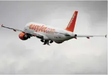  ?? — AFP ?? An Airbus plane of British low cost airline EasyJet as it takes off under heavy cloud in Geneva.