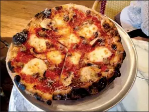  ?? Democrat-Gazette file photo ?? Neapolitan-style pizzas like this Pop Supreme will start popping out of the big, imported oven Friday at The Pizzeria, formerly the Pizzeria @ Terry’s Finer Foods.