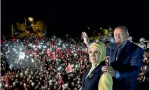  ?? PHOTO: REUTERS ?? Turkish President Recep Tayyip Erdogan, accompanie­d by his wife Emine Erdogan, addresses his supporters in Istanbul.