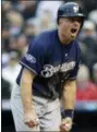  ?? JOE MAHONEY — THE ASSOCIATED PRESS ?? Milwaukee Brewers’ Erik Kratz reacts after scoring on a wild pitch thrown by Colorado Rockies reliever Scott Oberg in the sixth inning of Game 3 of a baseball National League Division Series, Sunday in Denver.