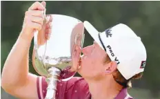  ?? — Reuters ?? Australia’s Cameron Smith kisses the trophy after winning the Australian PGA Championsh­ip at the Royal Pines Resort on the Gold Coast, in Australia.