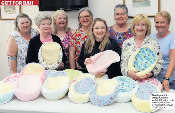  ??  ?? Thank you RAH charge nurse Lois Moffat, fifth left, accepts the baby nests from members of the Laugh ‘n’ Craft Group