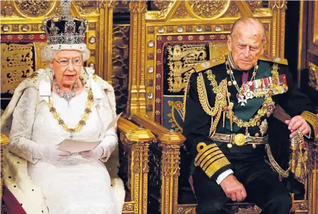  ??  ?? The Queen sits on the throne yesterday flanked by Prince Philip as she reads out the speech in the House of Lords