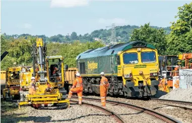  ?? JOHN STRETTON. ?? On August 12 2015, engineers work at Bathampton Junction (near Bath) as part of the Great Western Main Line electrific­ation project. NR has been heavily criticised for projects coming in late and over budget.