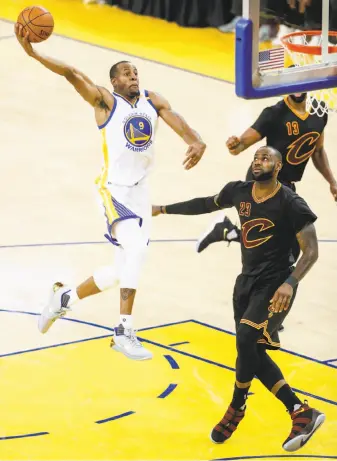  ?? Scott Strazzante / The Chronicle ?? Andre Iguodala, the Warriors’ invaluable sixth man, rises for a dunk in the second quarter of the championsh­ip-clinching win. He played more than 38 minutes and scored 20 points.