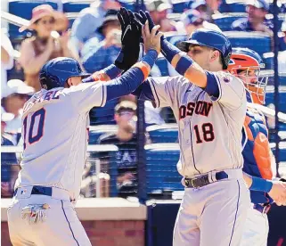  ?? MARY ALTAFFER/ASSOCIATED PRESS ?? The Houston Astros’ Jason Castro, right, and Yuli Gurriel celebrate after scoring on Castro’s two-run home run in the ninth inning of Wednesday’s game against the Mets in New York.