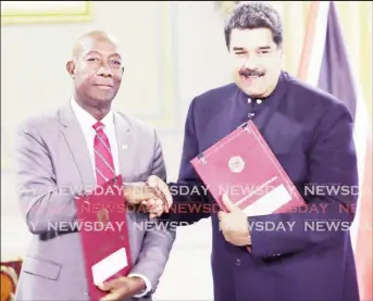  ?? (A TT Express file photograph) ?? Trinidad PM Keith Rowley shakes hands with Venezuelan President Nicolas Maduro back in August 2018, to seal the deal that will see TT for the first time, processing Venezuelan natural gas