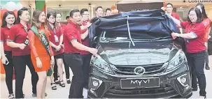  ??  ?? YANG BAHARU: Esther (kanan) dan Peter (lima kiri) melakukan simbolik pelancaran Perodua Myvi baharu di Sibu, kelmarin.