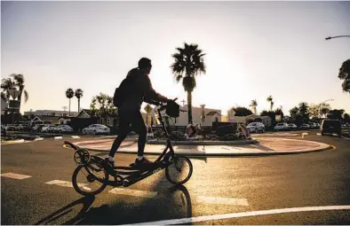  ?? SAM HODGSON U-T ?? A cyclist rides through a recently built roundabout at the corner of 39th Street and Meade Avenue in Normal Heights. Street alteration­s such as roundabout­s are used in some areas to reduce vehicle speeds.