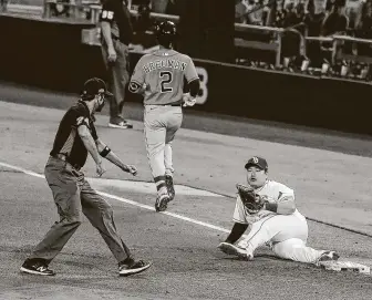  ??  ?? Rays first baseman Ji-Man Choi keeps his foot on the bag after making the grab to retire Alex Bregman on a fifth-inning grounder. Bregman later struck out as the go-ahead run in the eighth.