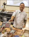  ?? Michael Henninger/CMU ?? Jet Tila hands a copy of his first cookbook, “101 Asian Dishes You Need to Cook Before You Die,” to a Carnegie Mellon student during his demonstrat­ion on Nov. 6.