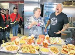  ?? JOE BURBANK /ORLANDO SENTINEL ?? Celebrity chef Guy Fieri, right, and restaurate­ur and business partner Robert Earl visit Chicken Guy!, their new restaurant at Disney Springs.