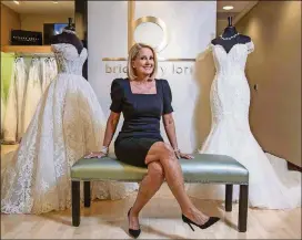  ?? ALYSSA POINTER / ALYSSA.POINTER@AJC.COM ?? Lori Allen opened a bridal shop out of college four decades ago and now has sold dresses to families of multiple generation­s.