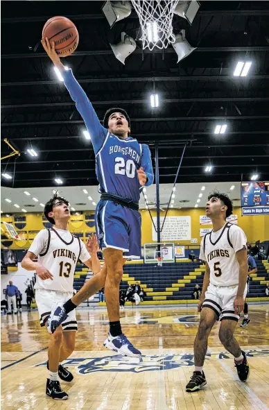  ?? ?? ABOVE: The Horsemen’s Marco C’de Baca shoots against the Vikings on Friday in the Bobby Rodriguez Capital City Tournament at Santa Fe High. C’de Baca hit the game-winning shot with 18 seconds left for the 46-44 win. St. Michael’s plays Santa Fe High on Saturday for the tournament title.