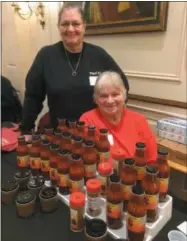  ?? PHOTOS BY PAUL POST — DIGITAL FIRST MEDIA ?? Judith Provo, standing, started her own small small business called Pa’s Pistols in South Glens Falls, featuring a variety of sauces, dips and barbecue rubs. She’s joined by Linda Gifford, of Gansevoort, who raises peppers for Provo’s food items. “Peppers don’t like me, but I can’t resist Judith’s Dorito corn salad,” Gifford says.