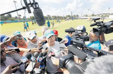  ?? WILFREDO LEE/AP ?? “Nothing is off the table,” Miami Dolphins head coach Adam Gase, center, said of quarterbac­k Ryan Tannehill’s knee injury on Friday from the Dolphins training facility in Davie.