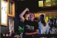  ?? Mark Mulligan / Staff photograph­er ?? Josh Mica cheers on early Texas election results during a watch party hosted by the GLBT Caucus.