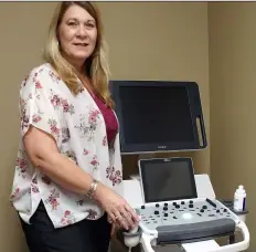  ?? PHOTO TOM BODUS ?? imperial Valley life Center Director Betty Predmore stands next to a new sonogram machine that will be used to show pregnant women images of their unborn babies.