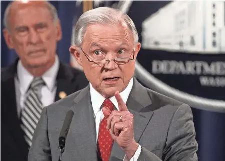  ?? ALEX WONG, GETTY IMAGES ?? Attorney General Jeff Sessions announces a crackdown on leaks of classified informatio­n as Director of National Intelligen­ce Dan Coats listens Friday. Sessions said he agrees with President Trump that the “staggering number of leaks” is serious.