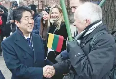  ??  ?? Abe is greeted by local residents as he arrives at the Sugihara House in Kaunas, Lithuania. — AFP photo