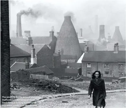  ??  ?? The smoking bottle kilns of the Staffordsh­ire potteries of Stoke- onTrent form a striking backdrop to this street scene from March 1946