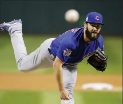 ?? GENE J. PUSKAR - THE ASSOCIATED PRESS ?? Chicago Cubs starting pitcher Jake Arrieta throws during the first inning of Game 2 of the World Series against the Cleveland Indians Wednesday in Cleveland. The Cubs won 5-1 to even the series.