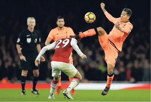  ?? AP ?? Liverpool’s Roberto Firmino (right) vies for the ball with Arsenal’s Granit Xhaka during their English Premier League match at the Emirates Stadium in London, yesterday.