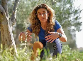  ?? (AFP) ?? This file photo shows Elena Sampson, an owner of an olive grove and farm, by a an olive tree at her premises in the village of Akaki in central Cyprus on November 12