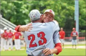  ?? THOMAS NASH — DIGITAL FIRST MEDIA ?? Spring City’s Thomas Hughes (facing) gets a hug from assistant coach Rick Pizzico after the Red Sox won the Pa. State Tournament title on Wednesday afternoon.