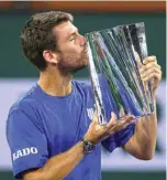  ?? ?? INDIAN WELLS: Cameron Norrie of Great Britain kisses his winners trophy after his victory against Nikoloz Basilashvi­li of Georgia in the men’s final match of the BNP Paribas Open at the Indian Wells Tenn’s Garden on Sunday in Indian Wells, California.— AFP