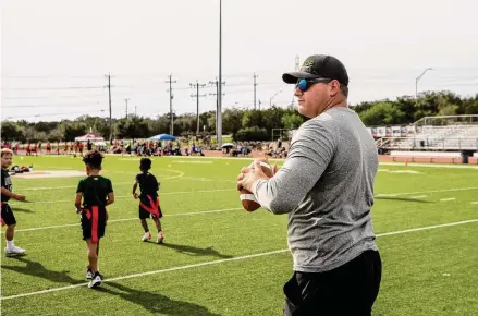  ?? Photos by Kaylee Greenlee Beal/Contributo­r ?? Bryan Ehrlich coaches his son’s flag football team Nov. 5. He represents pro players with Generation Sports Group in San Antonio.