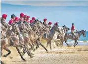  ?? ?? At ease: horses and troops of the Household Cavalry Mounted Regiment enjoy a ‘summer camp’ at Holkham beach in Norfolk, left, and face inspection at the Platinum Jubilee in 2022, below