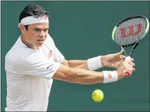  ?? AP PHOTO ?? Milos Raonic of Canada returns to Mackenzie McDonald of the US during their men’s singles match on the seventh day at the Wimbledon Tennis Championsh­ips in London, Monday.