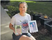  ??  ?? Anne Ramirez holds pictures of her father, Army veteran Norm Harpole, and of Norm and Vivian Harpole on Friday in front of her home. Norm and Vivian passed away recently.