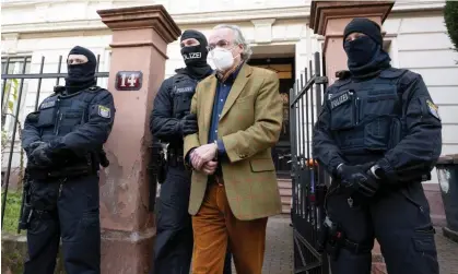  ?? Photograph: Boris Roessler/AP ?? Police lead out Heinrich XIII Prince Reuss during a raid in Frankfurt in December 2022. The group allegedly planned to install him as Germany’s provisiona­l new leader.