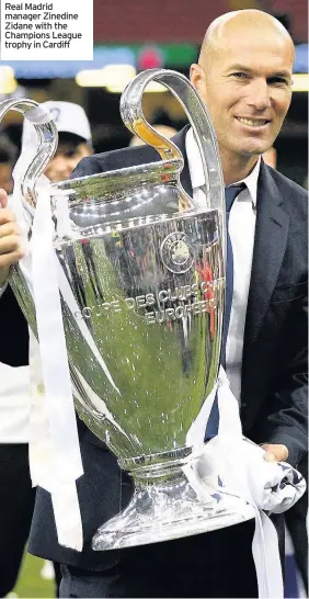  ??  ?? Real Madrid manager Zinedine Zidane with the Champions League trophy in Cardiff