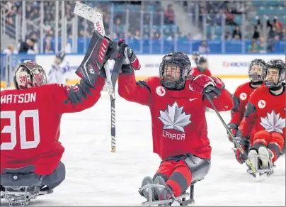  ?? AP PHOTO ?? Summerside’s Billy Bridges, centre, celebrates a goal with goalie Corbin Watson during Thursday’s semifinal against South Korea at the Paralympic­s in South Korea.