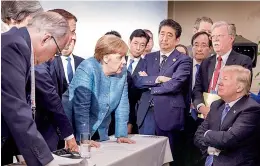  ?? — AFP ?? German Chancellor Angela Merkel speaks with US President Donald Trump during the G7 Leaders Summit in La Malbaie, Quebec, Canada
