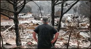  ?? Max Whittaker / New York Times file photo ?? A man looks over the rubble left by a wildfire in Spanish Flat, Calif., in August.