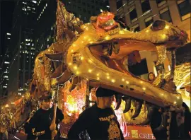  ?? ANDA CHU — STAFF ARCHIVES ?? A dragon made of recycled material waits along Market Street to start marching in the Chinese New Year Parade in San Francisco on Feb. 8. The 2021 event has been canceled.