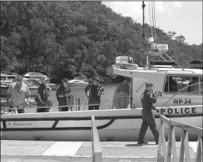  ?? AP/RICK RYCROFT ?? Police and Australian Transport Safety Bureau investigat­ors board a police boat to head to the scene of a seaplane crash in the Hawkesbury River near Sydney on Monday.