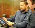  ??  ?? Shearing contractor Shane Ratima, left, shows farmer Stuart Fraser the new online woolshed injury prevention programme Tahi Nga¯ tahi at a workshop in Palmerston North.