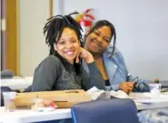  ?? STAFF PHOTO BY OLIVIA ROSS ?? Taja Reeves and Chrystil Hires sit together on the first day of the EMPACT program Monday at the Youth and Family Developmen­t Center. The nine-week program allows the students to receive their Google informatio­n technology certificat­ion.