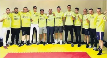  ??  ?? Fundraisin­g champions Sam Allan (far left) with the gym’s boxers on the night